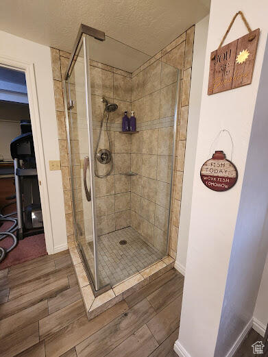 Bathroom with wood-type flooring and an enclosed shower