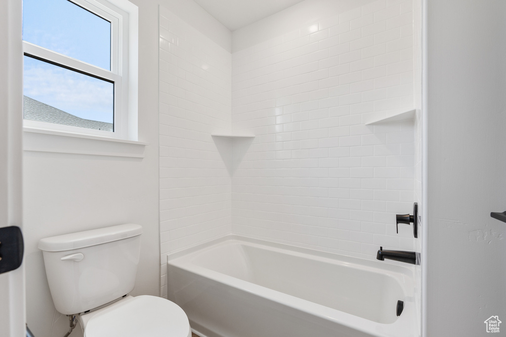 Bathroom featuring bathing tub / shower combination and toilet