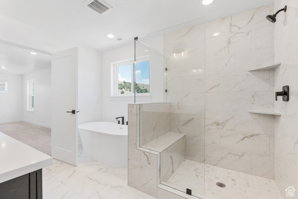 Bathroom with tile patterned floors and plus walk in shower