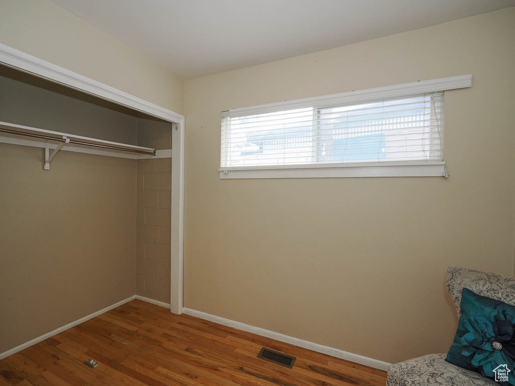 Unfurnished bedroom with a closet and dark wood-type flooring
