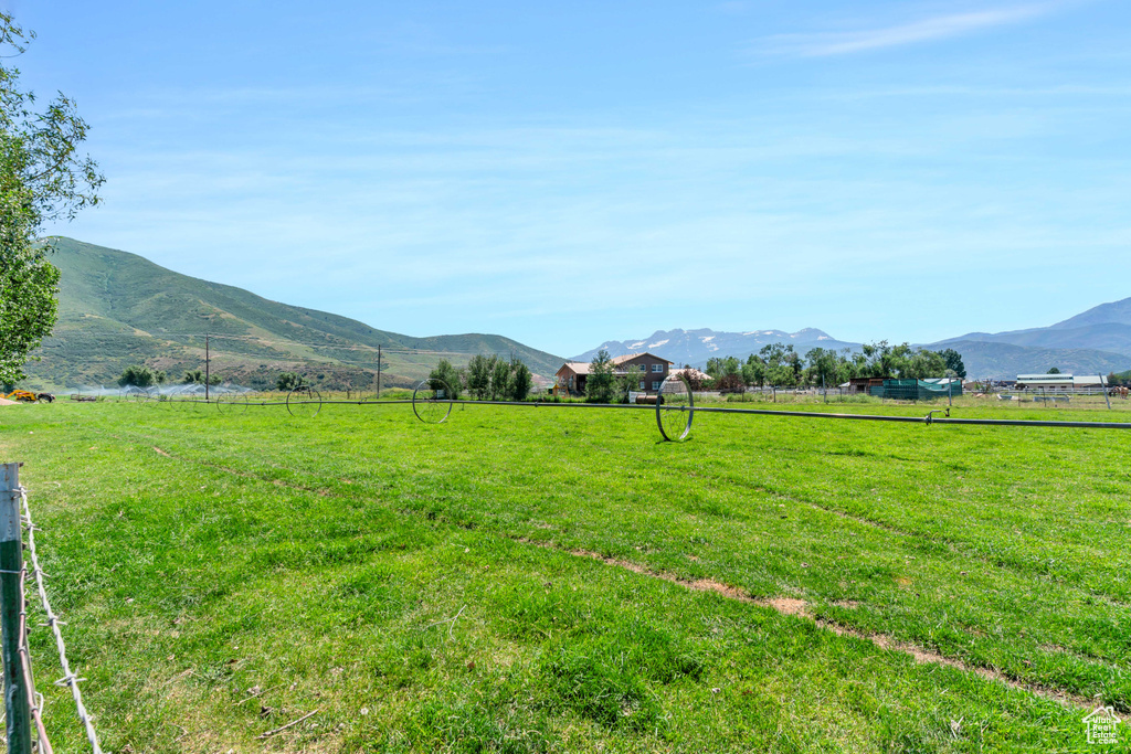View of yard with a rural view and a mountain view