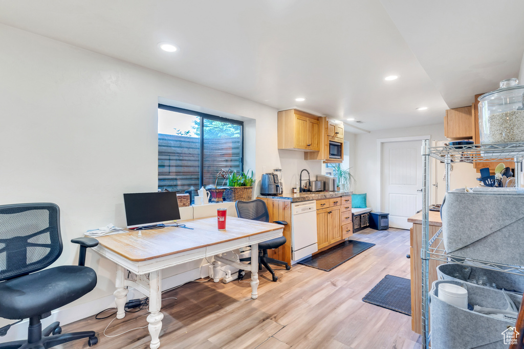 Office space featuring light hardwood / wood-style flooring and sink