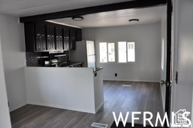 Kitchen featuring dark hardwood / wood-style flooring and white refrigerator