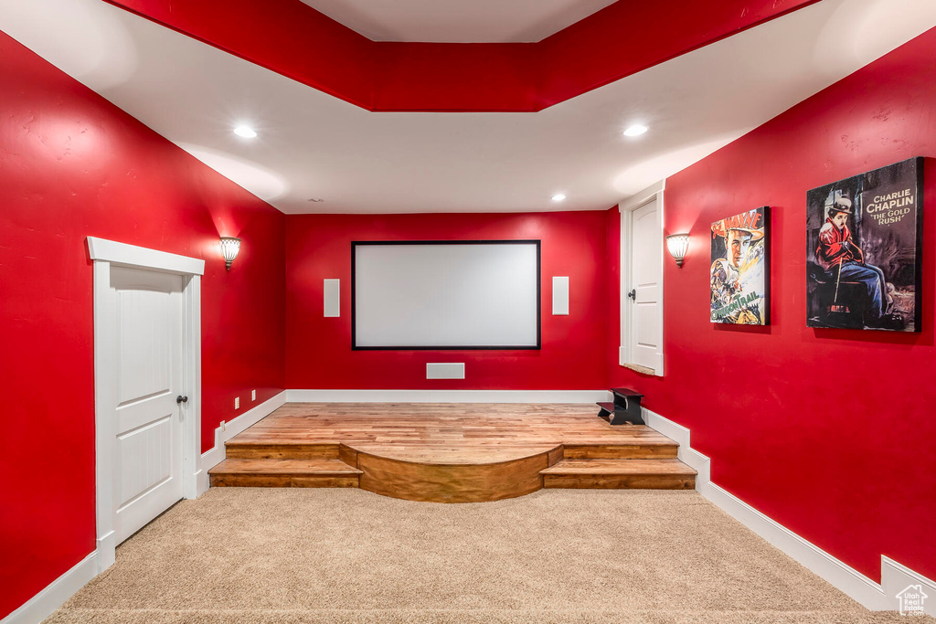 Home theater room with light colored carpet