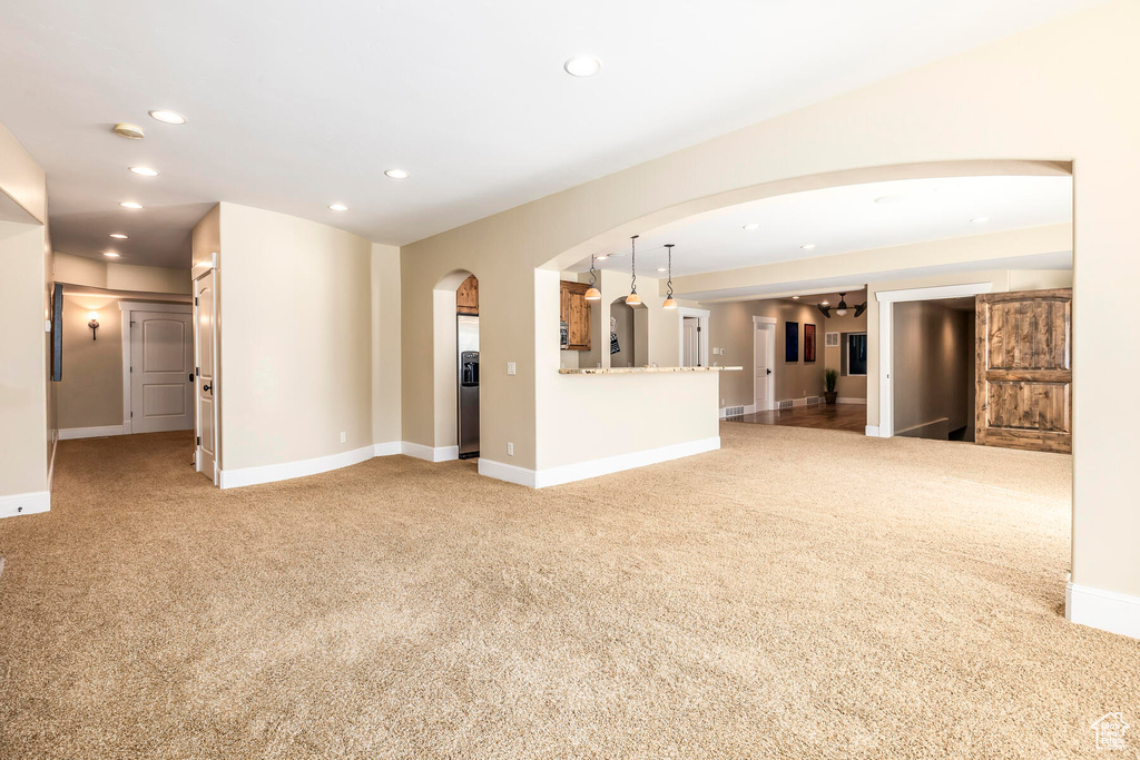 Unfurnished living room featuring light colored carpet