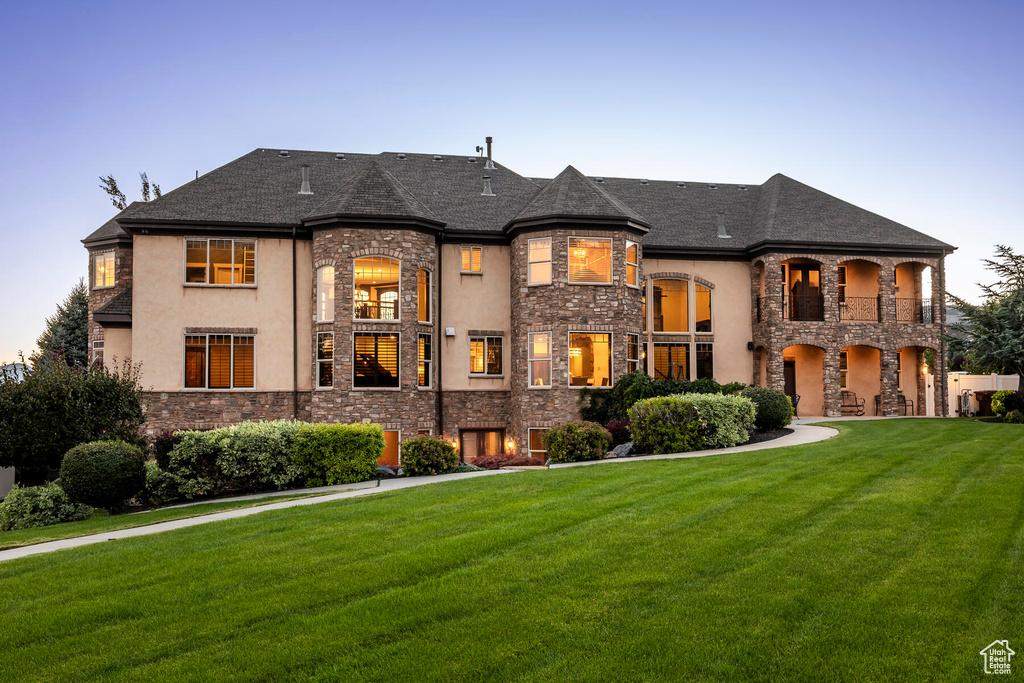 French provincial home with a yard and a balcony