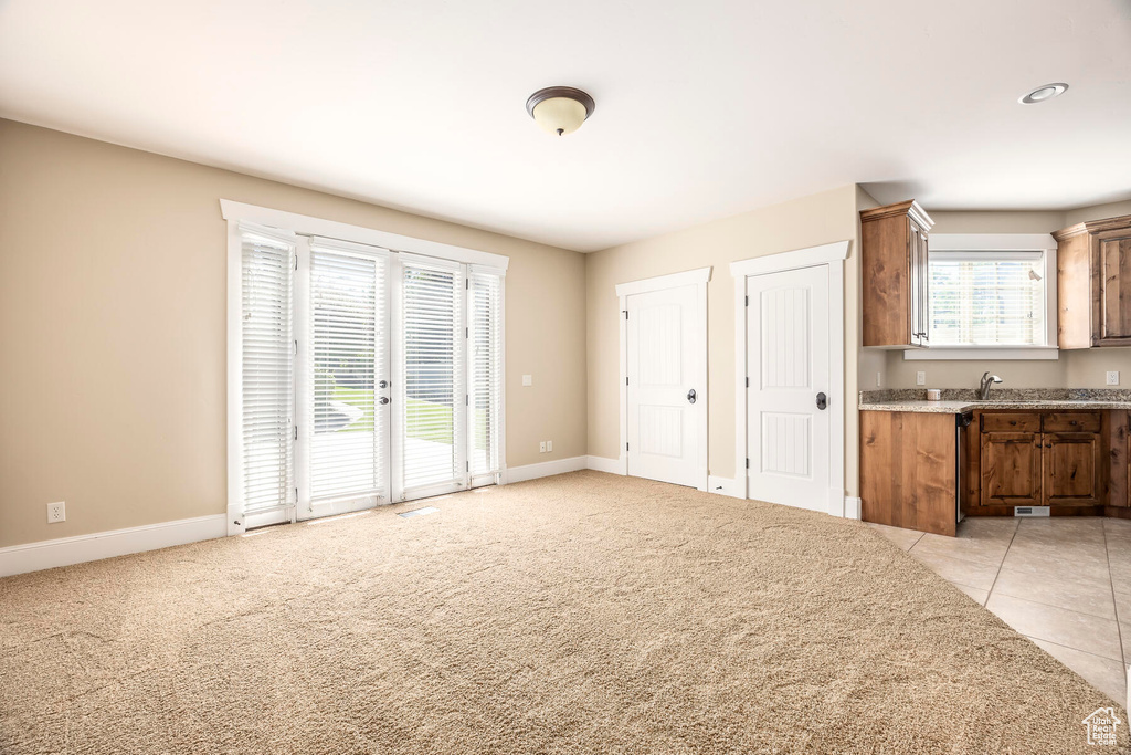 Interior space featuring sink and light tile patterned flooring