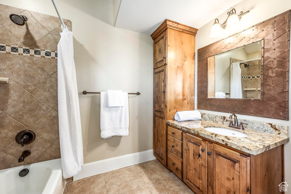 Bathroom with shower / tub combo with curtain, vanity, and tile patterned floors