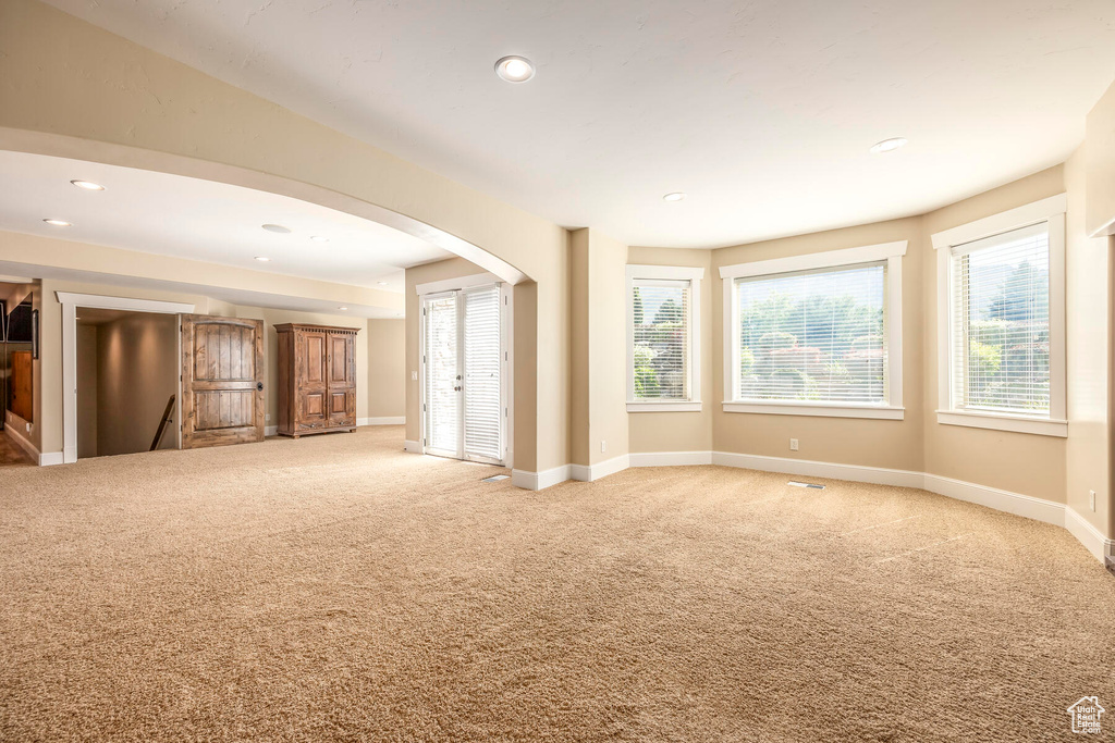 Unfurnished living room with light carpet