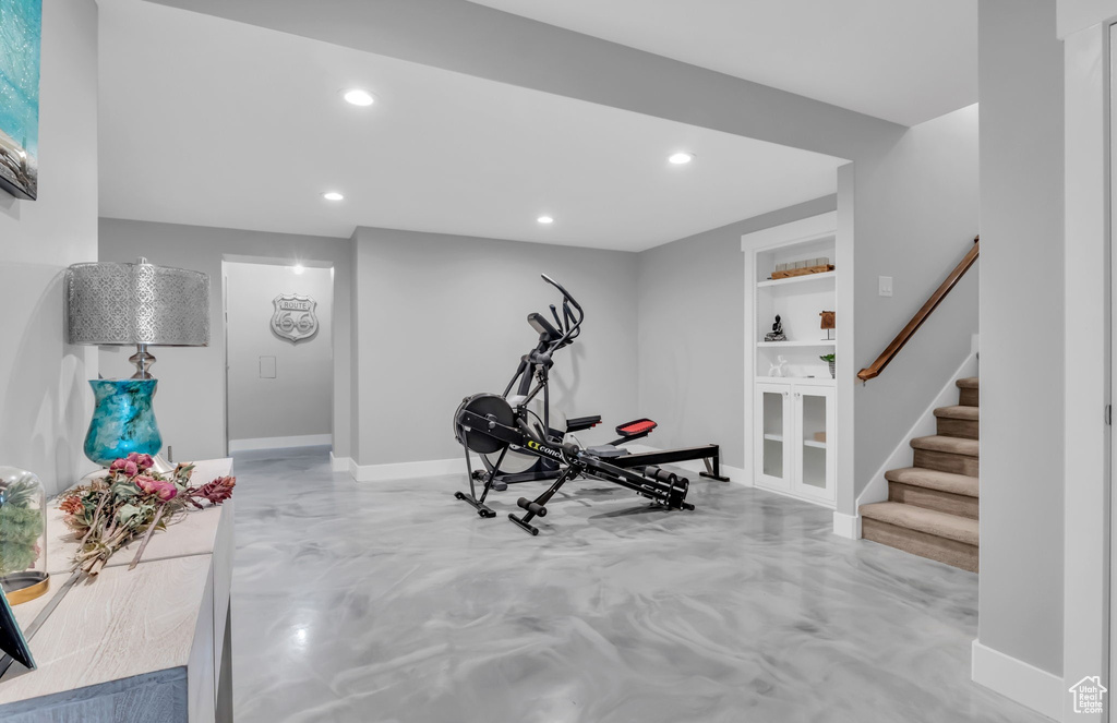 Exercise room featuring built in shelves