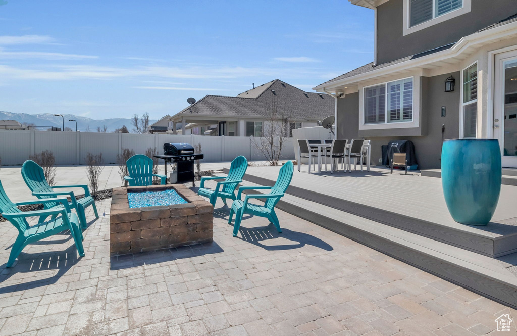 View of patio featuring a deck, an outdoor fire pit, and area for grilling