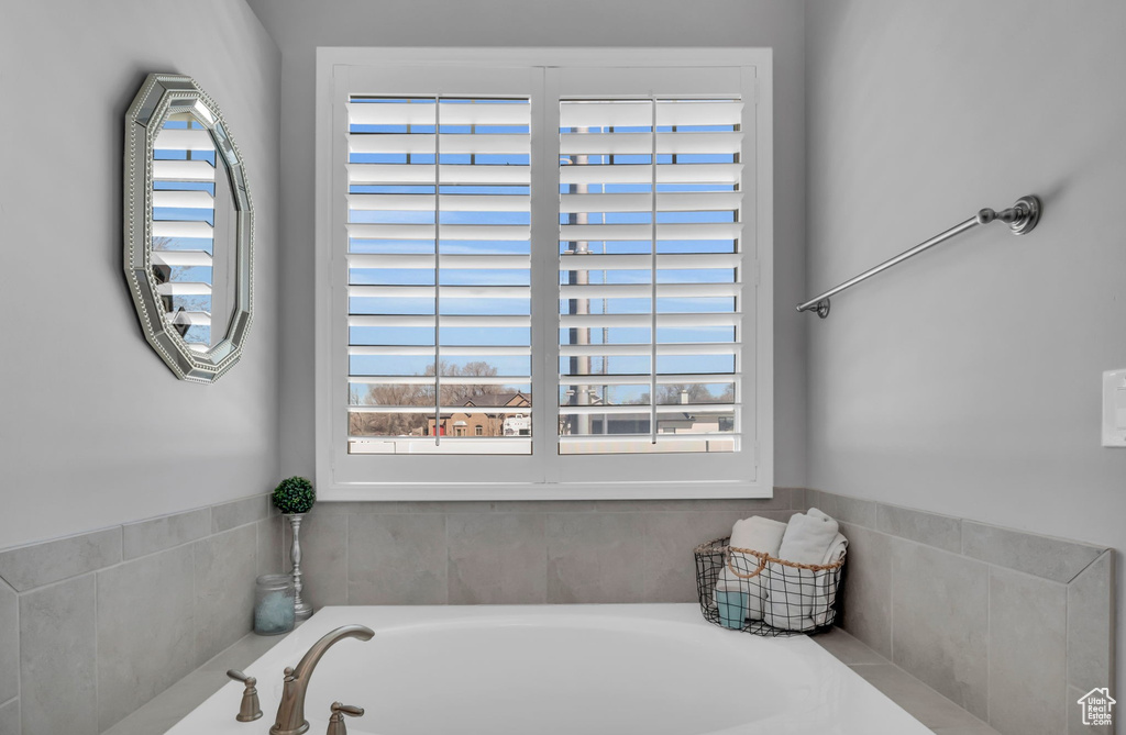 Bathroom with a washtub and plenty of natural light