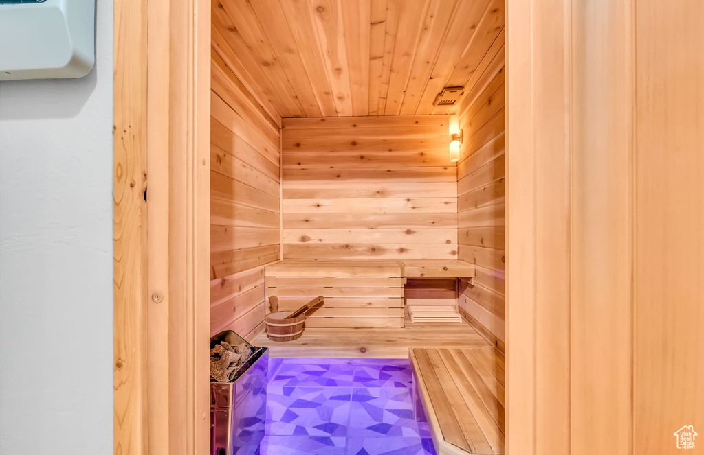 View of sauna / steam room with wood walls and wood ceiling