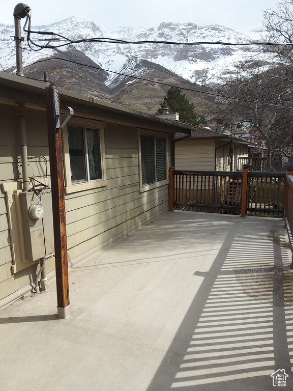 Exterior space featuring a deck with mountain view and a patio area