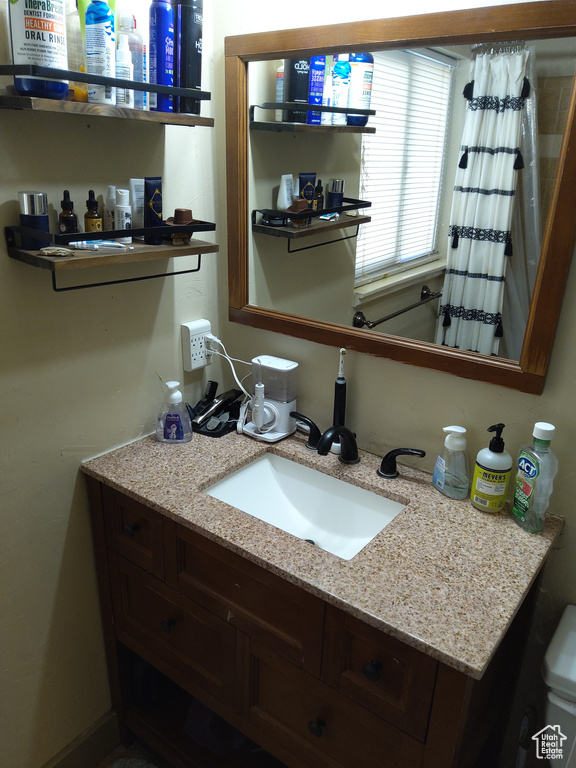 Bathroom with vanity with extensive cabinet space