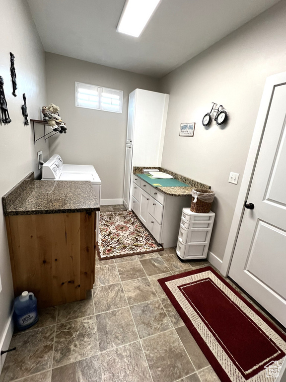 Bathroom with vanity, tile floors, and independent washer and dryer