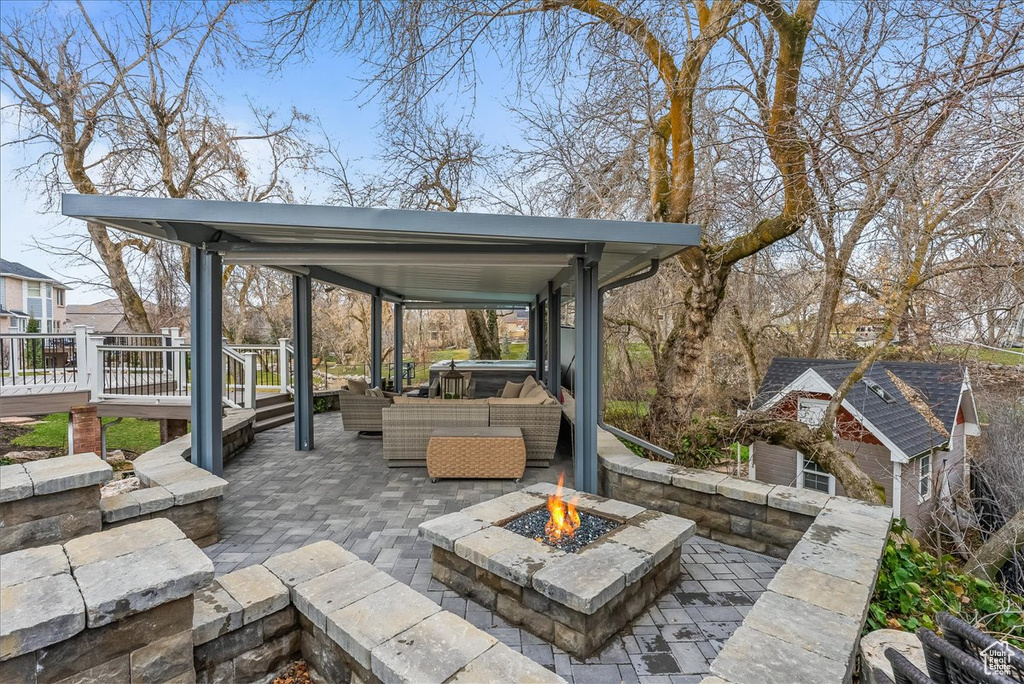 View of patio / terrace featuring an outdoor living space with a fire pit and a wooden deck