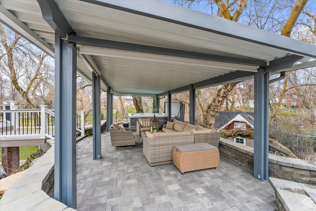View of patio / terrace featuring a wooden deck and an outdoor living space