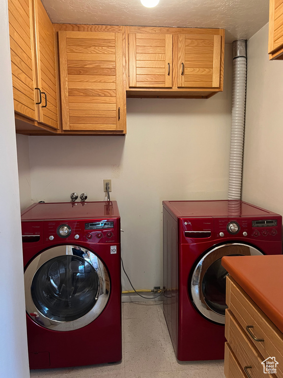 Washroom with cabinets and independent washer and dryer