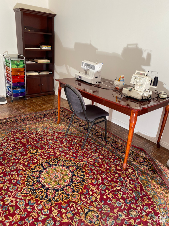 Home office featuring dark parquet flooring