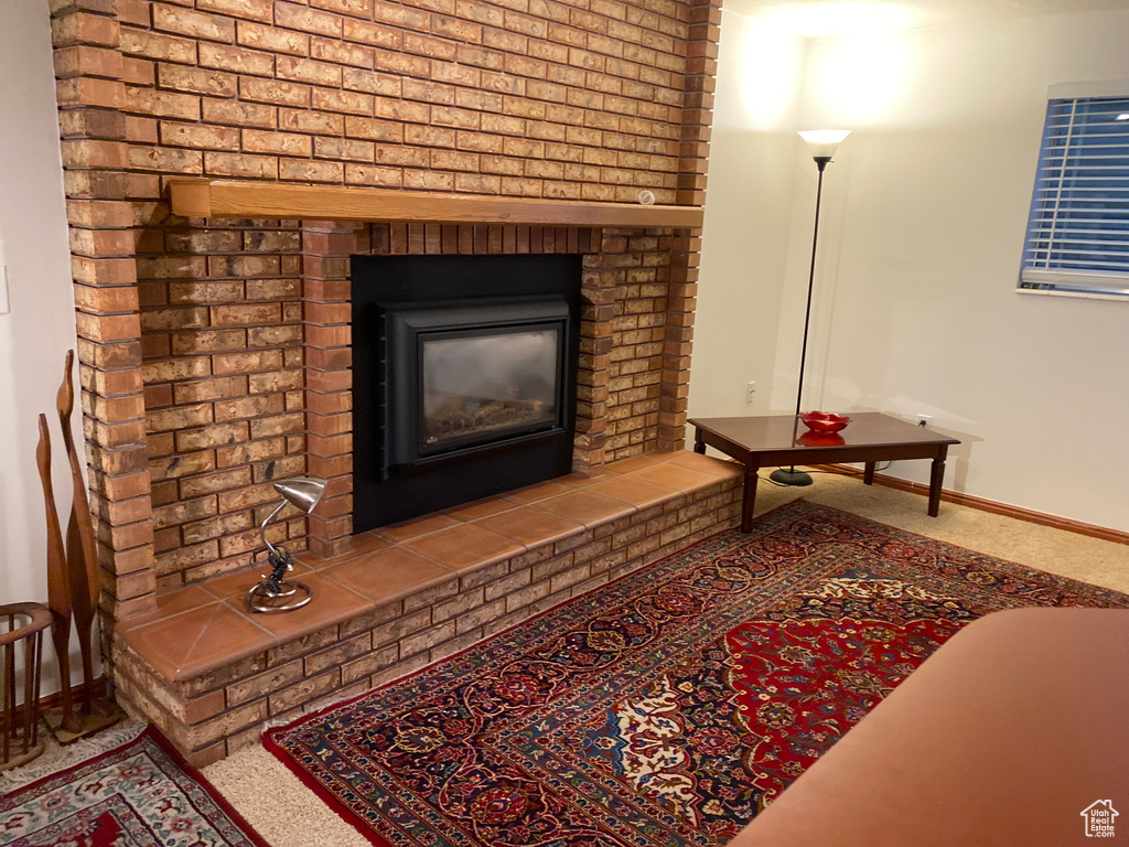 Details featuring a fireplace and carpet floors