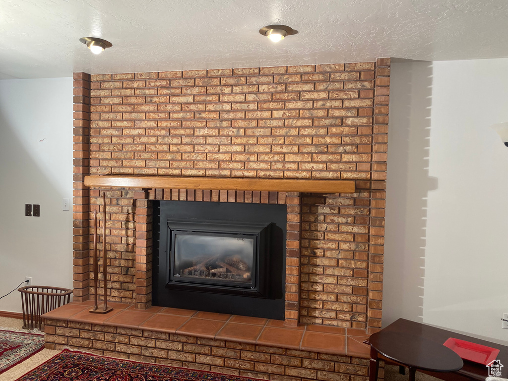 Details with a fireplace and a textured ceiling