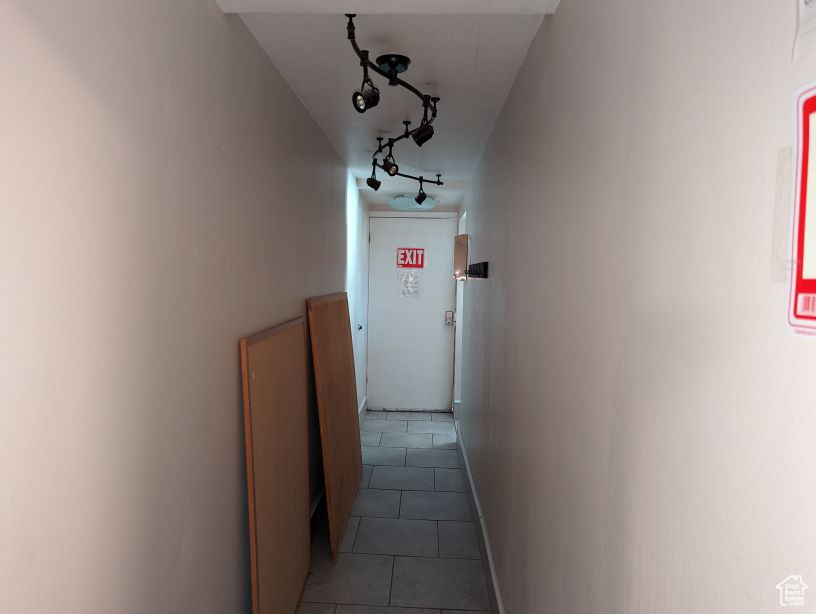 Hallway featuring light tile floors