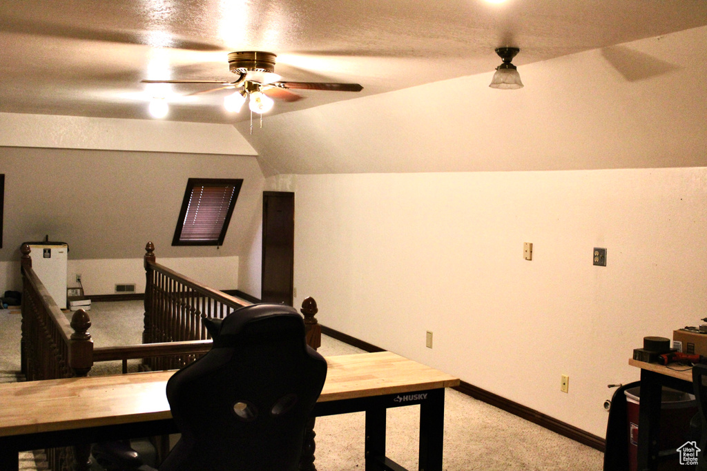 Office area featuring lofted ceiling, ceiling fan, and carpet