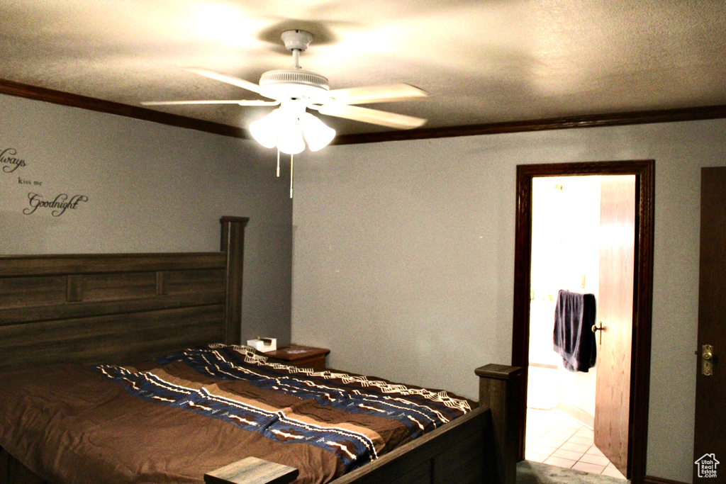 Tiled bedroom featuring crown molding and ceiling fan