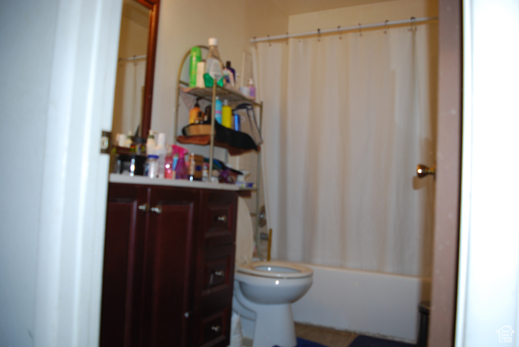 Full bathroom with vanity, toilet, and shower / bath combo