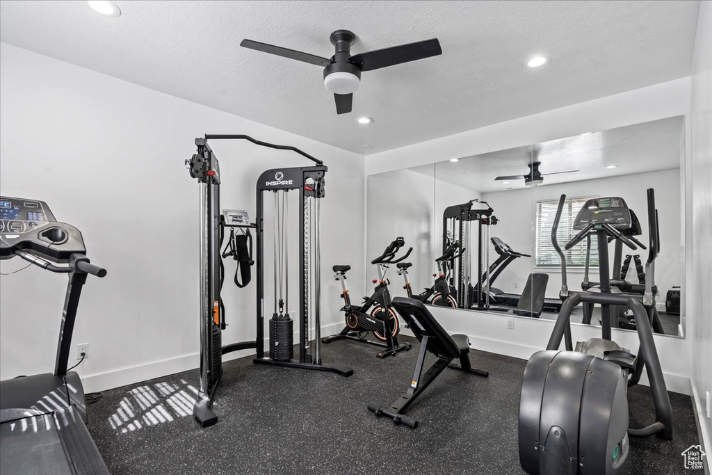 Workout area with a textured ceiling and ceiling fan