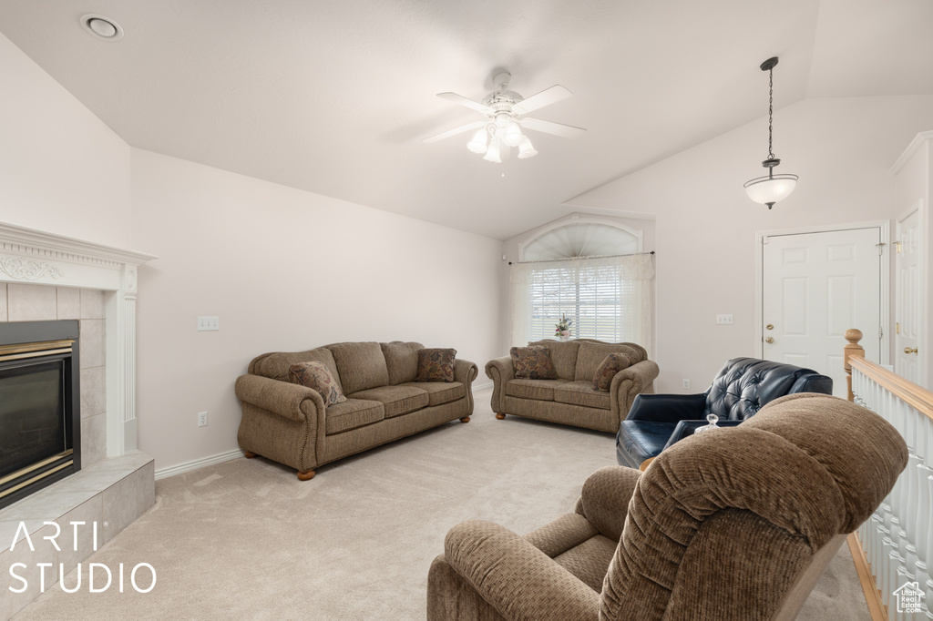 Living room with a fireplace, light carpet, vaulted ceiling, and ceiling fan