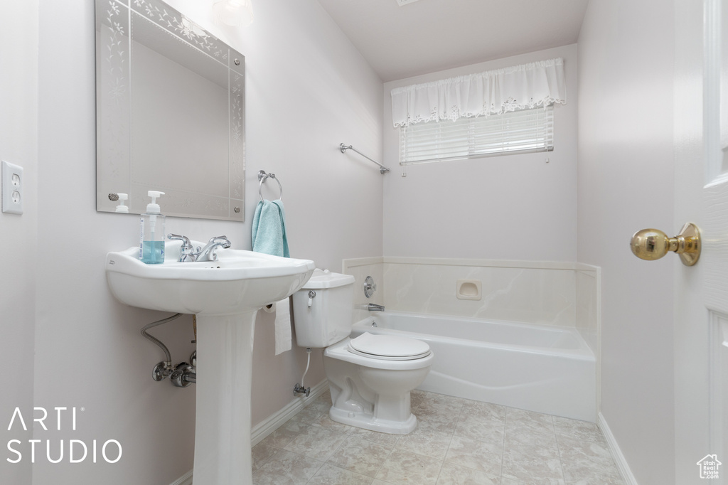 Bathroom featuring a washtub, tile flooring, and toilet
