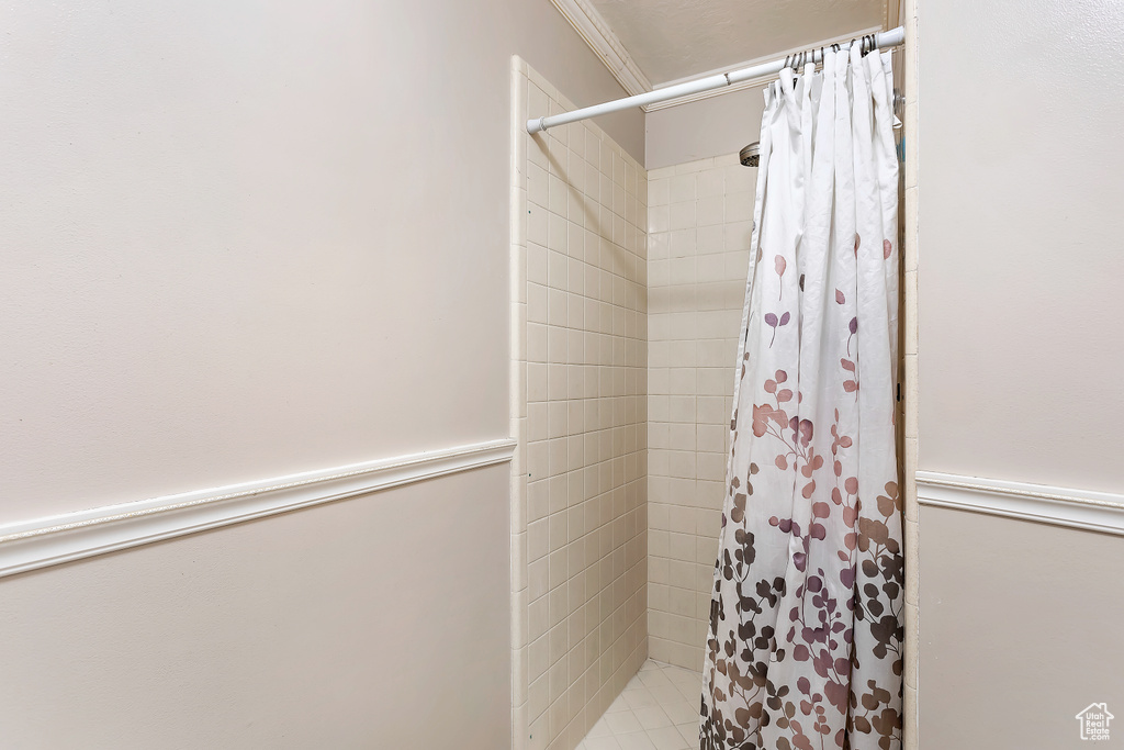 Bathroom featuring walk in shower and ornamental molding
