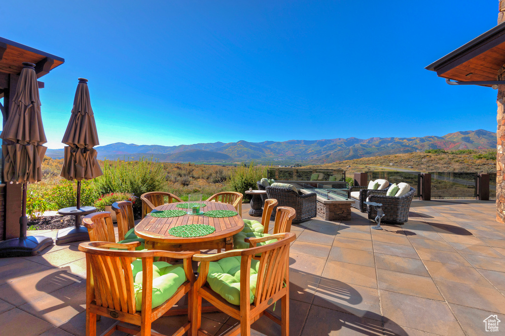 View of patio featuring a mountain view and an outdoor hangout area