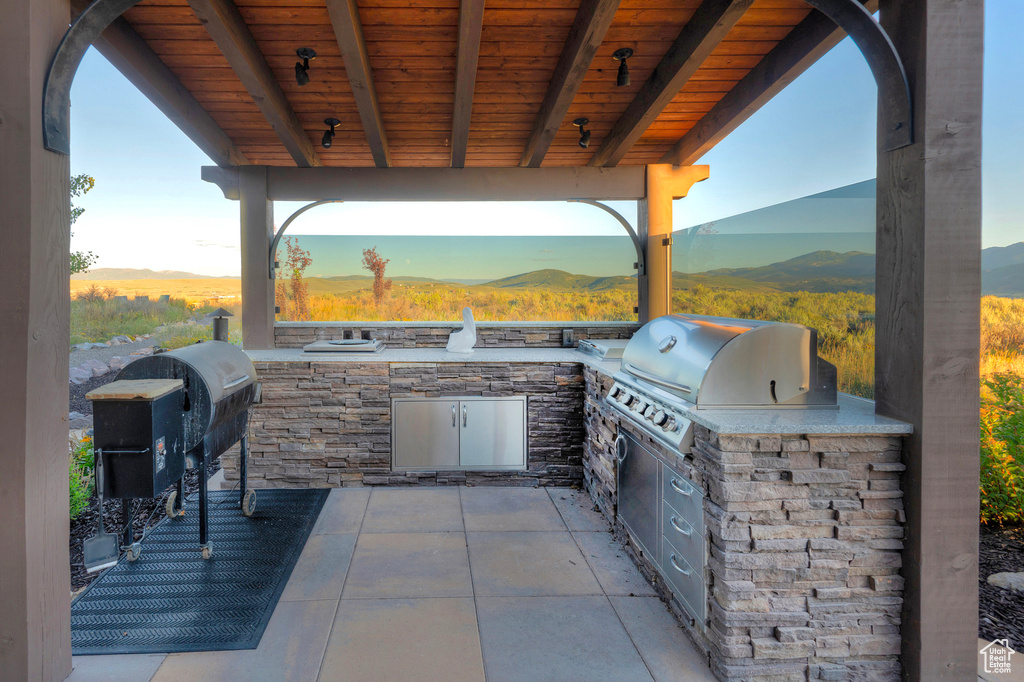 View of patio / terrace with a mountain view, exterior kitchen, and area for grilling