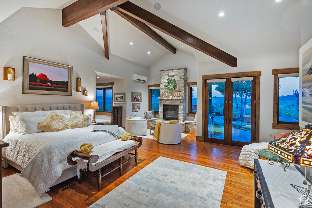 Bedroom with access to outside, a fireplace, high vaulted ceiling, hardwood / wood-style flooring, and an AC wall unit