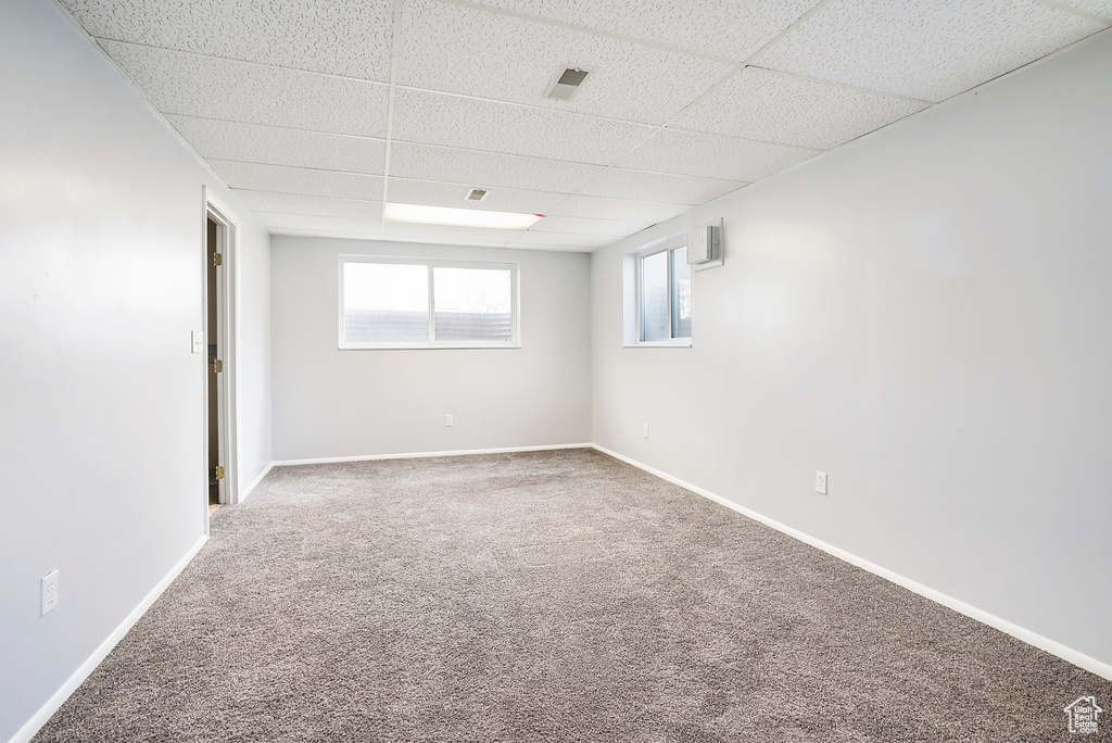 Unfurnished room featuring carpet flooring and a drop ceiling