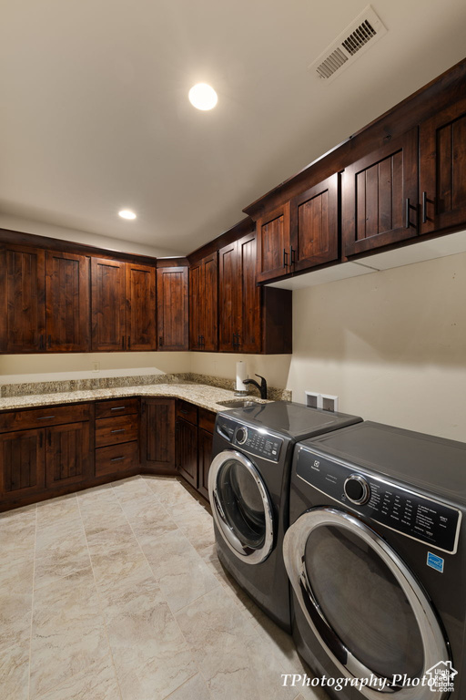 Laundry room with cabinets, washer and clothes dryer, light tile flooring, washer hookup, and sink