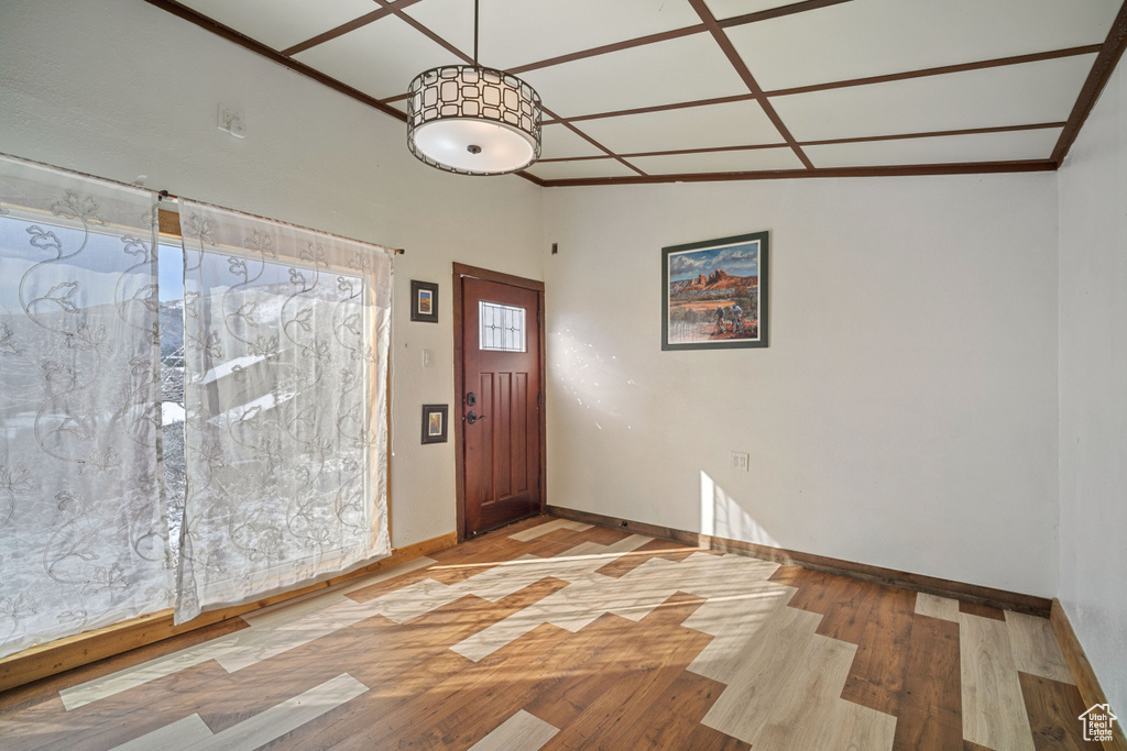 Foyer entrance featuring light wood-type flooring and vaulted ceiling