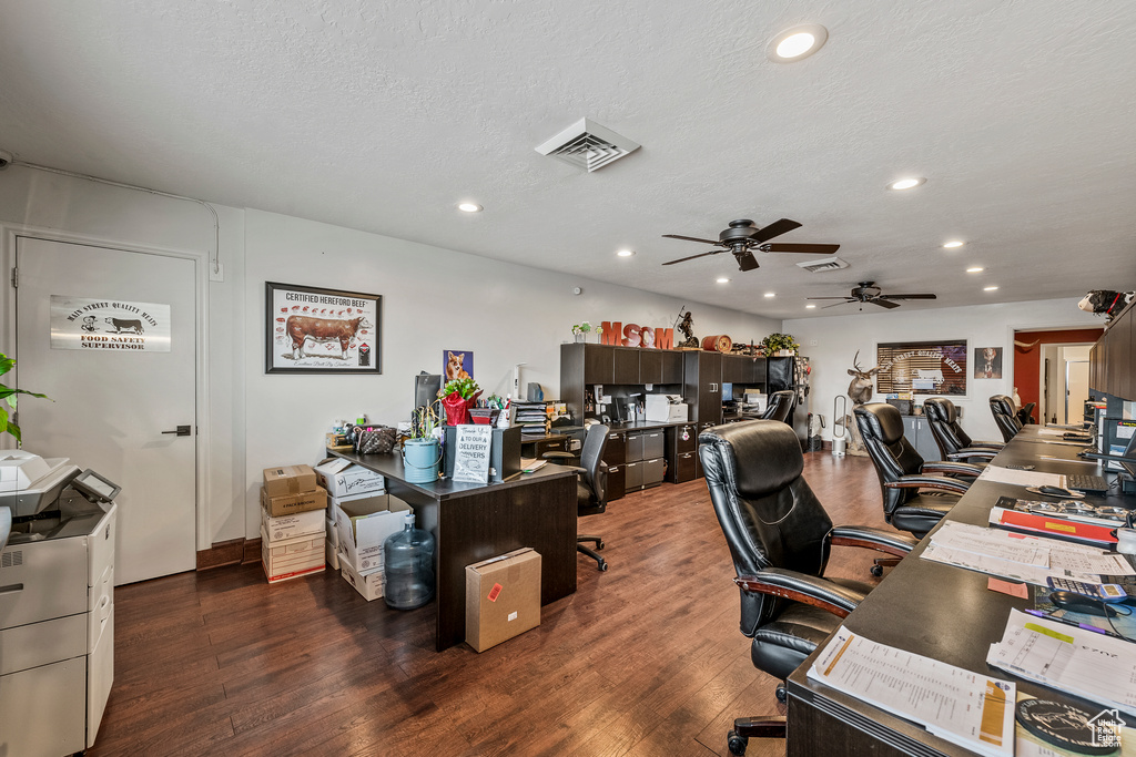 Office space featuring a textured ceiling, dark wood-type flooring, and ceiling fan