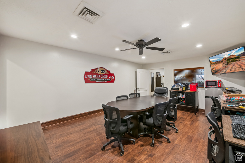 Office featuring dark hardwood / wood-style flooring and ceiling fan