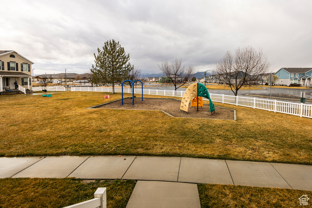 View of playground featuring a lawn