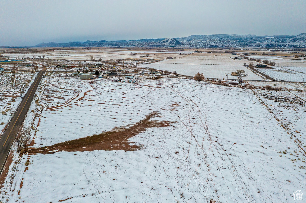 Snowy aerial view with a rural view and a mountain view