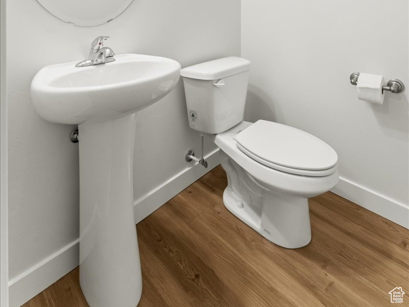 Bathroom with toilet and hardwood / wood-style floors