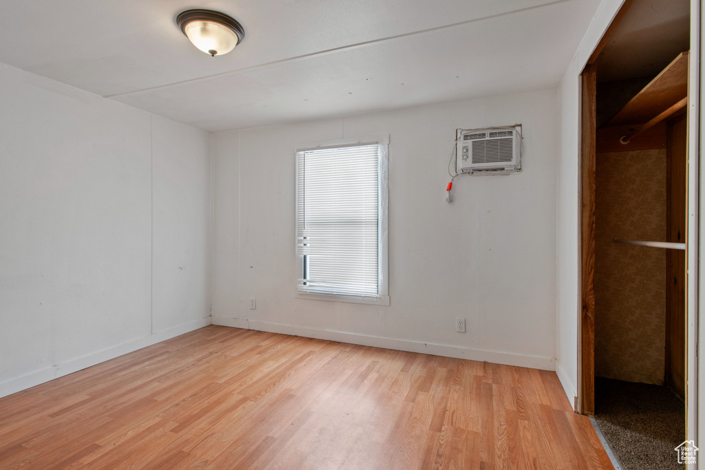 Interior space featuring a wall mounted AC and light hardwood / wood-style floors