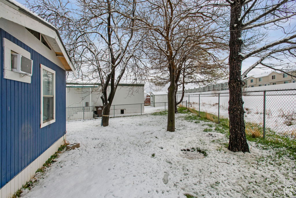 Snowy yard with an outdoor structure
