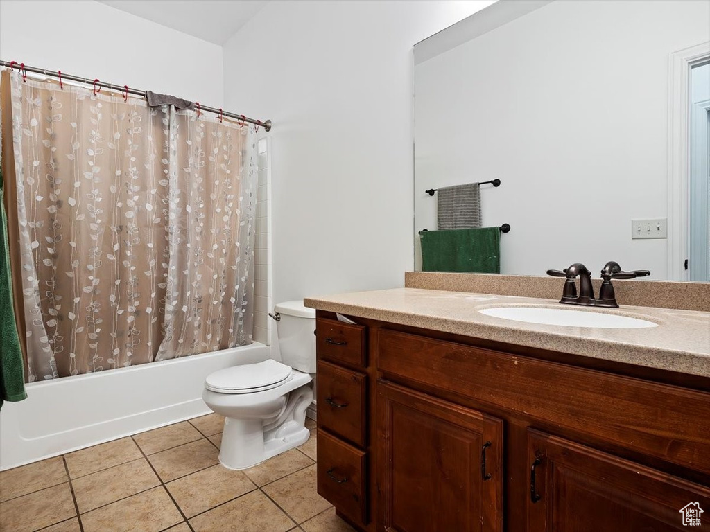 Full bathroom featuring tile floors, vanity, shower / bath combination with curtain, and toilet