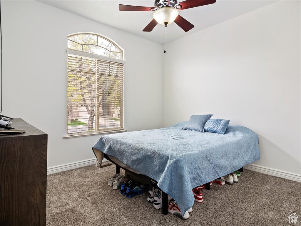 Bedroom featuring ceiling fan and carpet floors