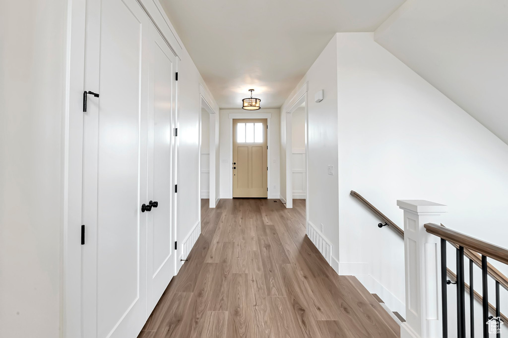Hallway with light hardwood / wood-style flooring